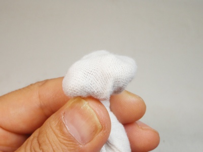 ガーゼにクルミの実を包んで油を搾ってククサを磨く